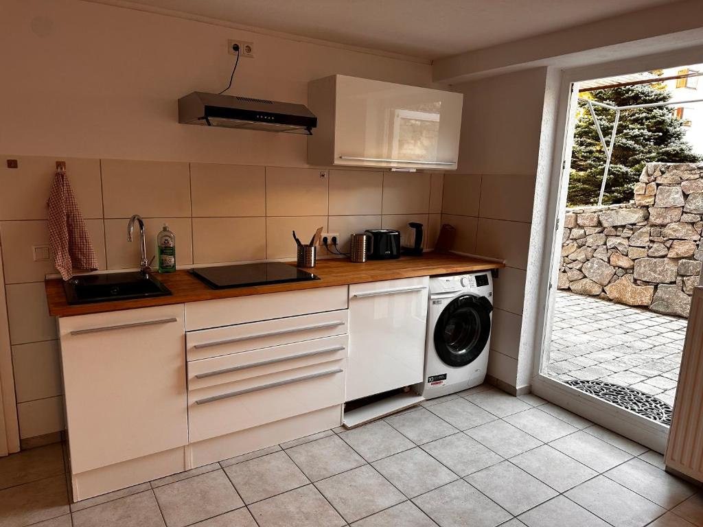 a kitchen with a sink and a washing machine at Monteurwohnung Inzlingen nahe Basel in Inzlingen