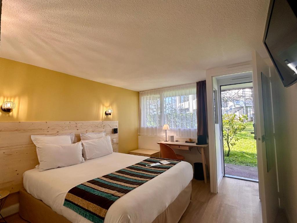 a bedroom with a large bed and a window at Sure Hotel by Best Western Biarritz Aeroport in Biarritz
