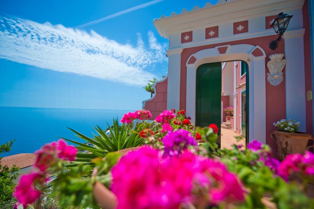 a painting of a building with pink flowers at Palazzo Rocco Villa Sunshining in Love in Praiano