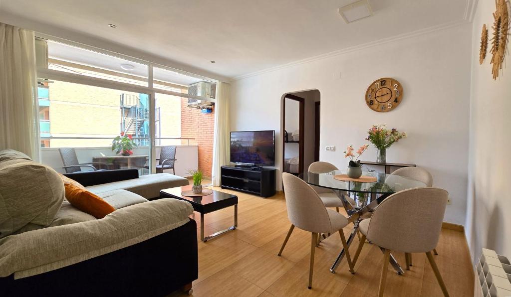 a living room with a couch and a table at NEXTHOME Beach & Pool in Lloret de Mar