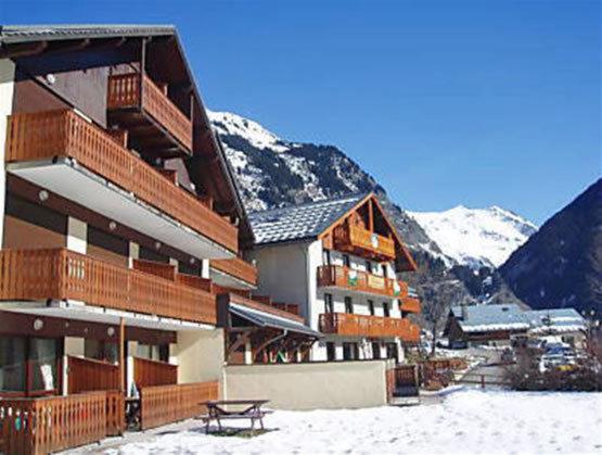 a large building with a picnic table in the snow at Champagny Ski Studio - Le Dahut in Champagny-en-Vanoise