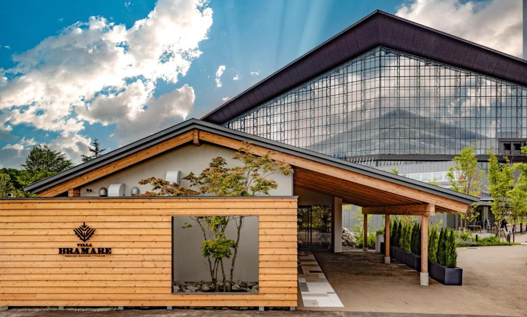 a building in front of a glass building at ヴィラブラマーレ in Kitahiroshima