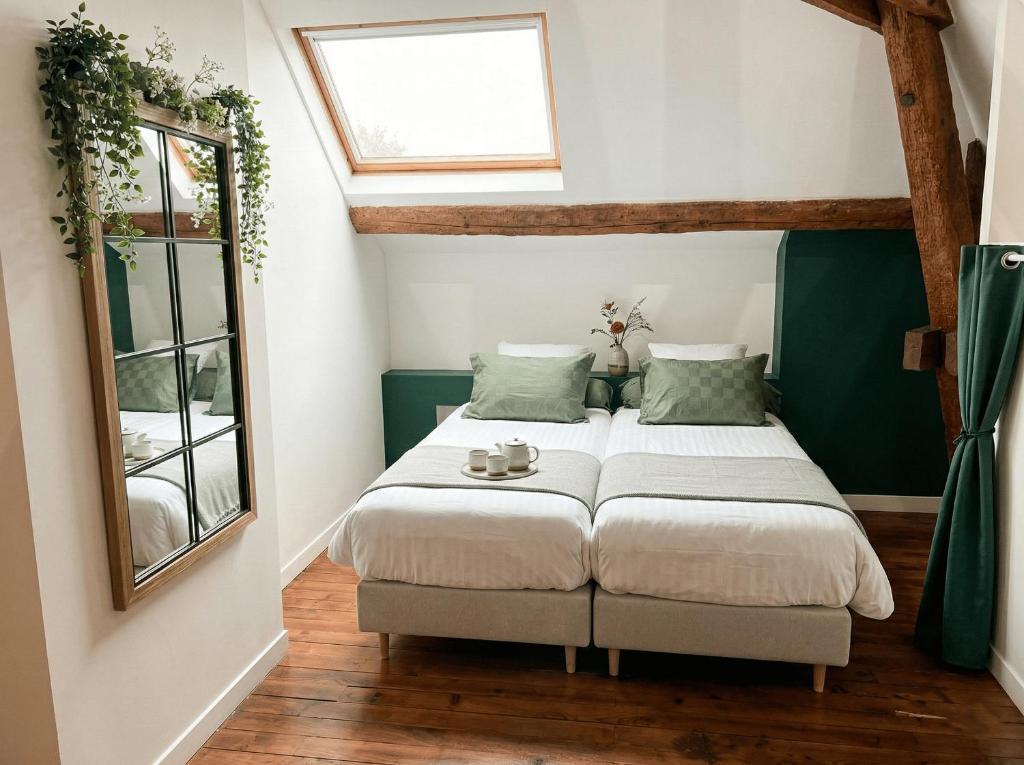 a small bedroom with a bed and a window at Maison Maubert in Thiers
