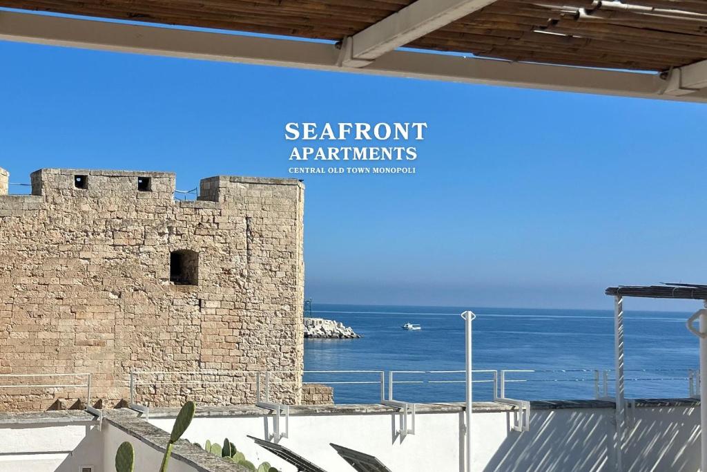 a sign that reads seafront athibitals in front of a castle at Seafront Apartments in Monopoli Old Town in Monopoli