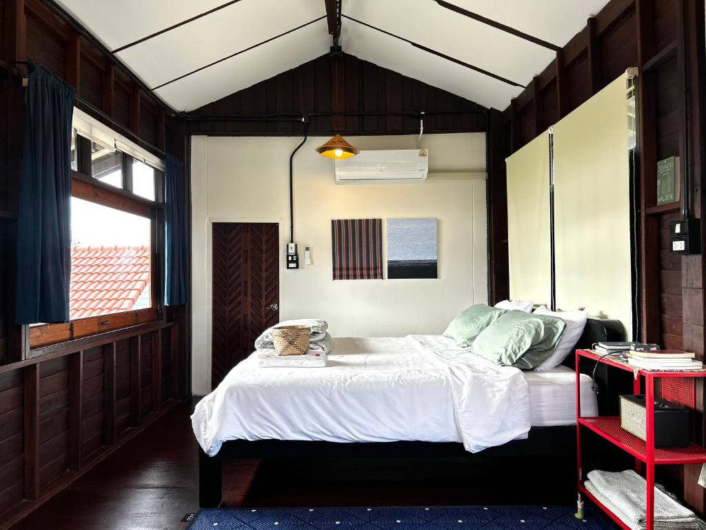 a bedroom with a large bed in a house at Ponko Home in Ban Si Than