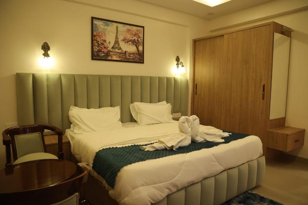 a hotel room with a bed with a towel on it at Navrasa By CDF in Vrindāvan