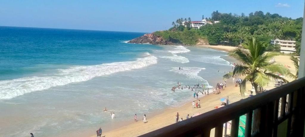 a view of a beach with a group of people at Hotel Searock in Trivandrum