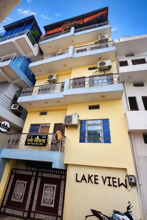 a tall yellow building with the words lake view on it at Hotel Lake View in Varanasi