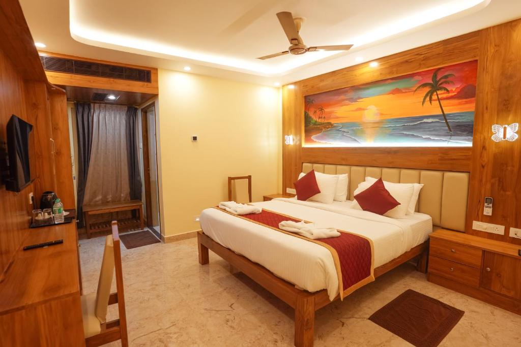 a bedroom with a large bed in a room at Le Kumar Residency in Pondicherry