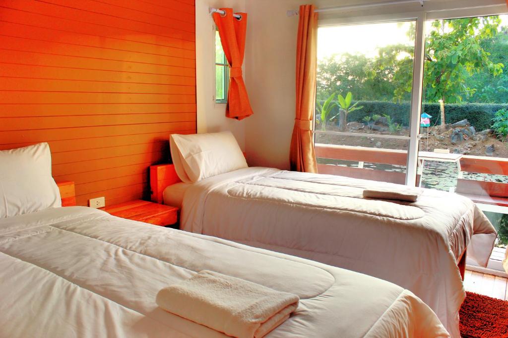 Postel nebo postele na pokoji v ubytování Sakul Plang Resort