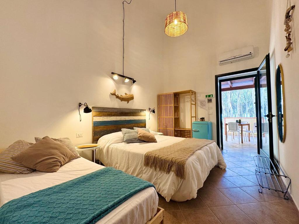 a bedroom with two beds in a room at Eraclea Minoa Village in Montallegro