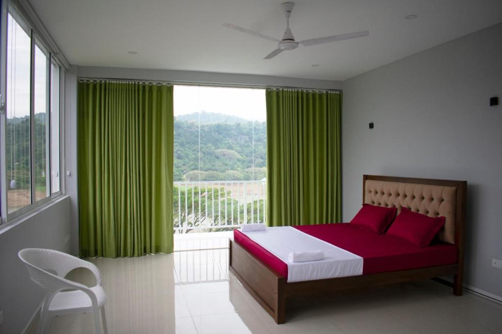 a bedroom with a bed and a window with green curtains at The Cliff Kandy in Gonawatta