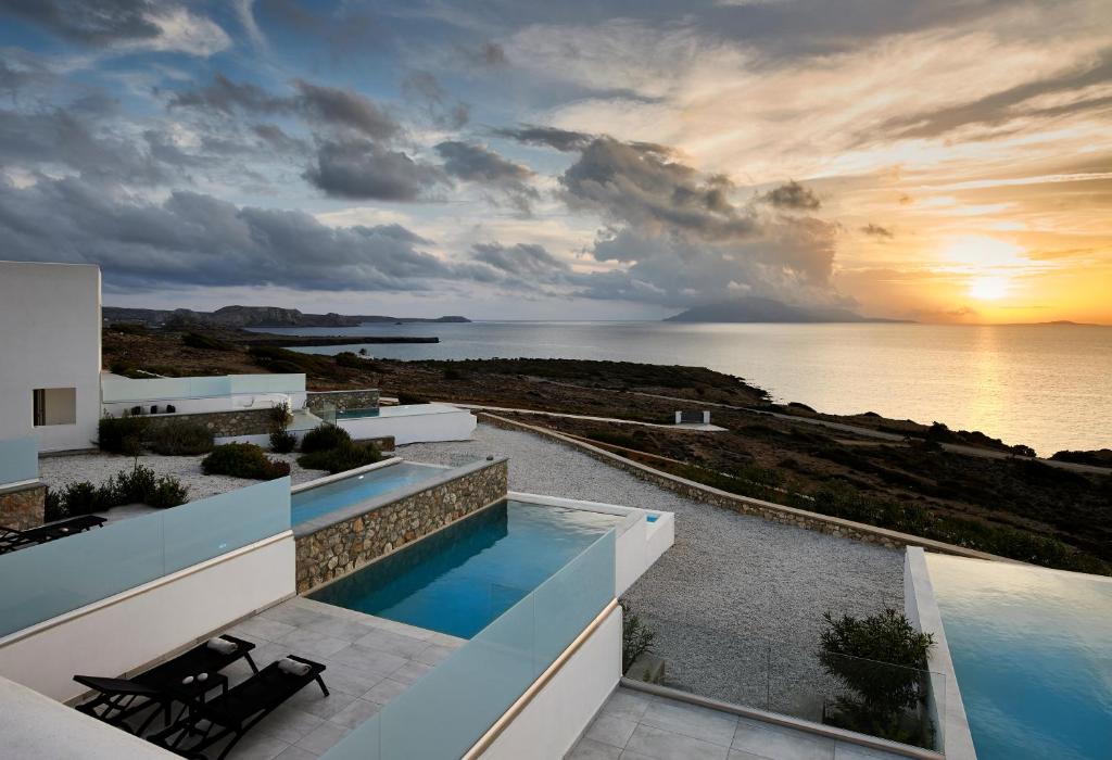 a view of the ocean from a house with a swimming pool at Arpathea Villas in Foiníkion