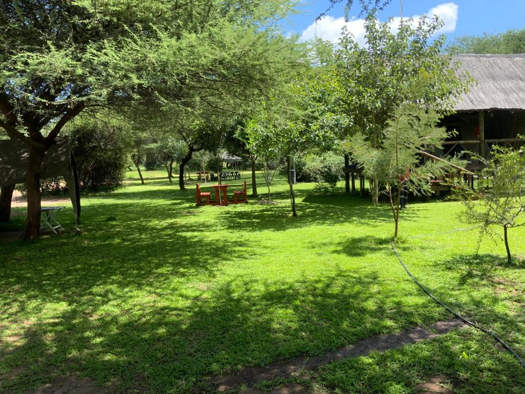 a park with a picnic table in the grass at Lorato Camping in Chobe