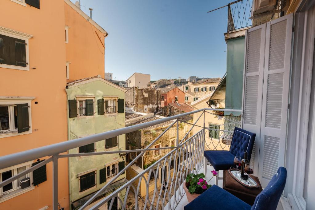 a balcony with chairs and a view of a city at Venetian Balcony , Old Town Corfu in Corfu
