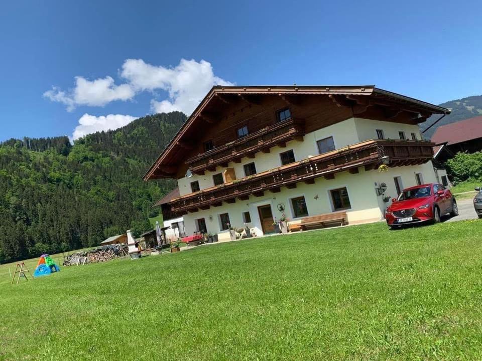 a house with a red car parked in front of it at Appartement Steinblick -Obinghof- in Maishofen