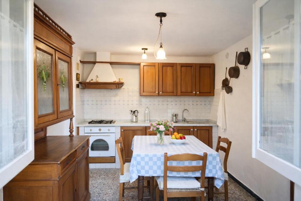 a kitchen with a table and chairs and a kitchen with a sink at Casa Lapè in Levanto