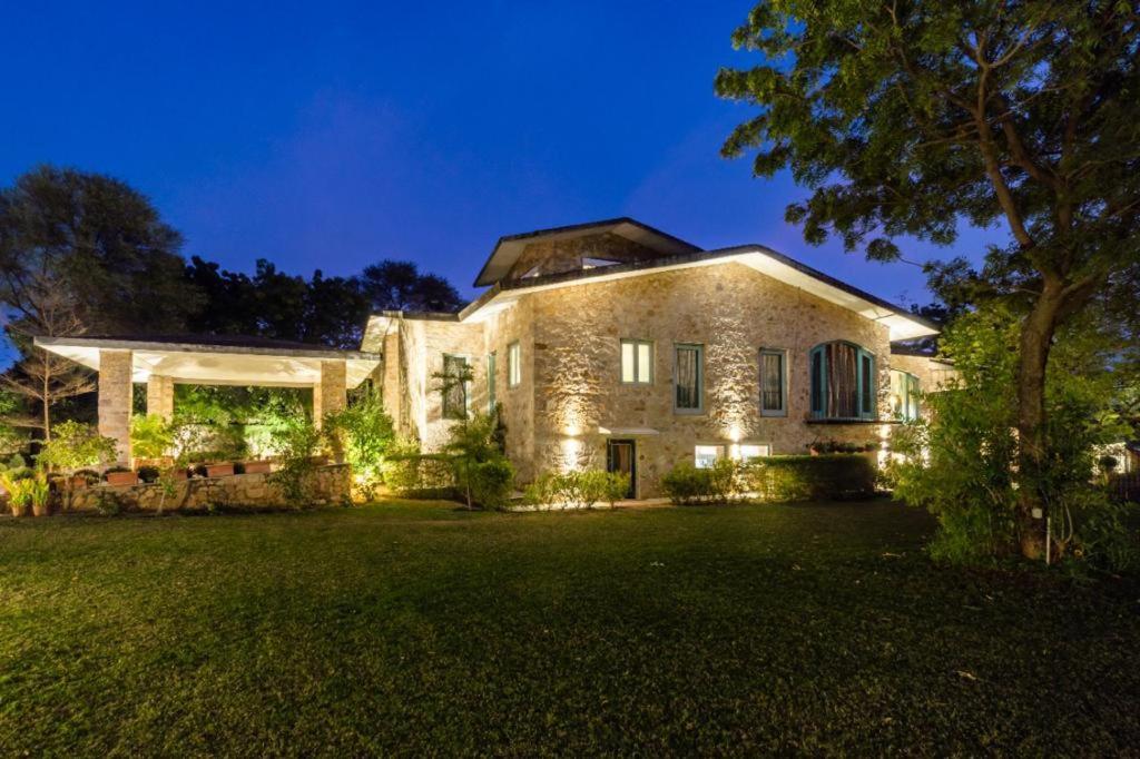 a large stone house with lights in the yard at 5 Bedroom Villa Amer in Jaipur