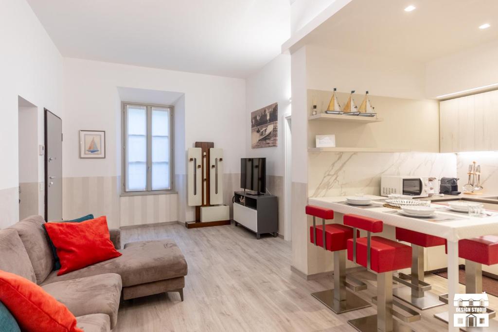 a kitchen and living room with a couch and a table at SANTA MARTA by Design Studio in Bellano