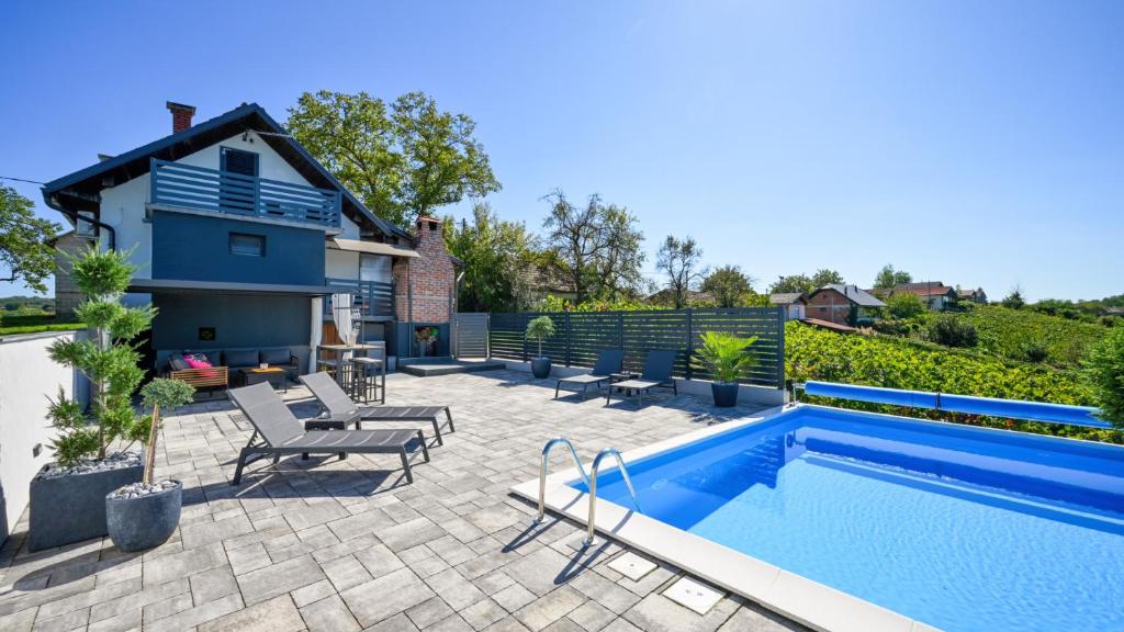 a patio with a swimming pool and a house at Villa Vinea by Villas Guide in Novakovec