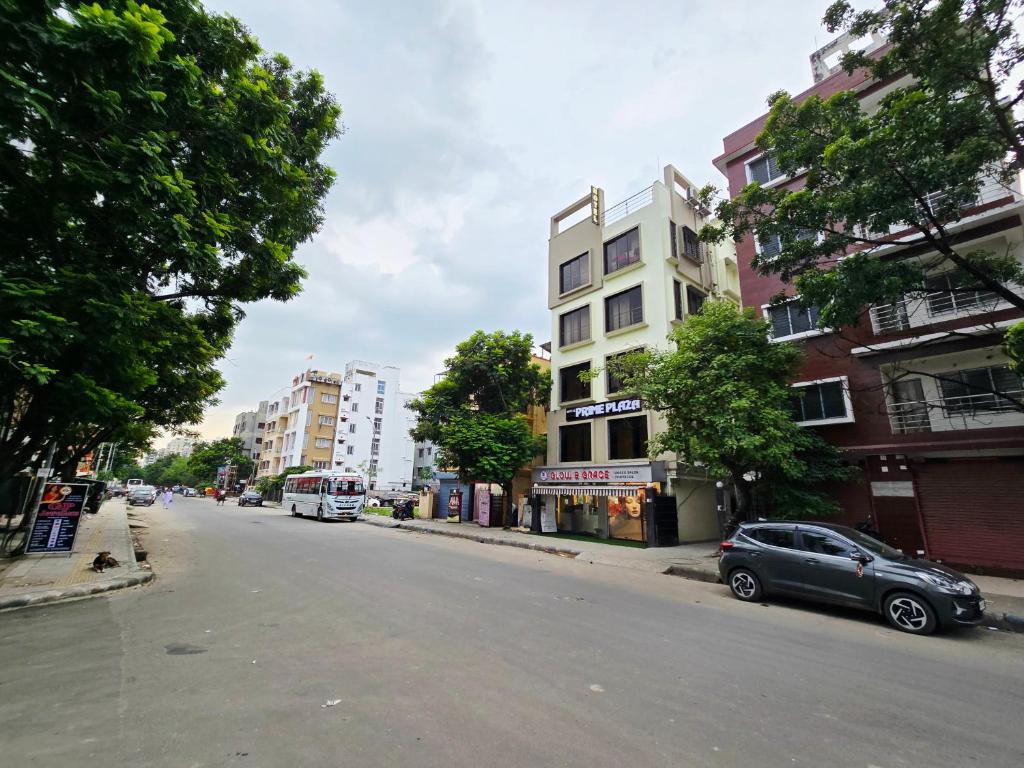 a car parked on the side of a city street at hotel Prime Plaza Newtown in kolkata