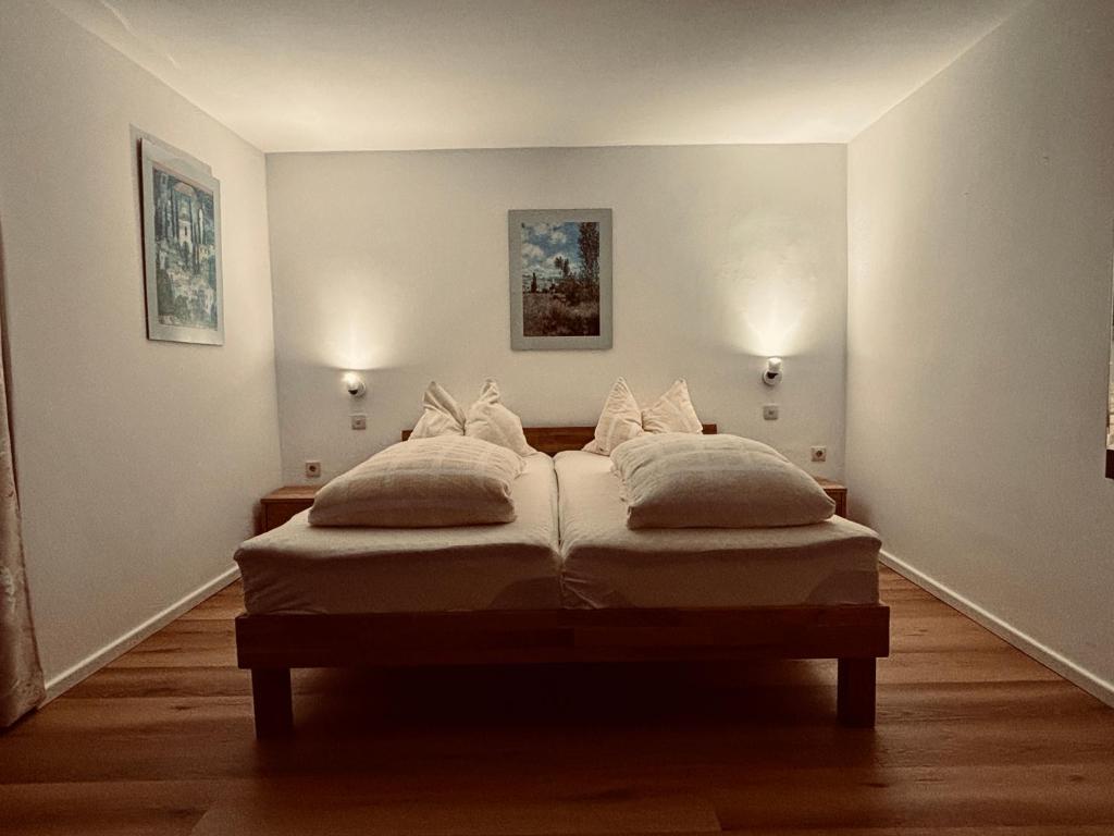 a bed in a room with two pillows on it at Hotel Tannenhof in Egmating