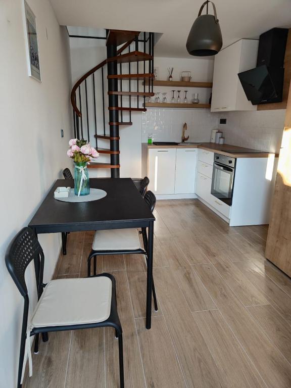 a kitchen and dining room with a table and chairs at Modern 4 stars Apartment with terace & free parking in Šibenik