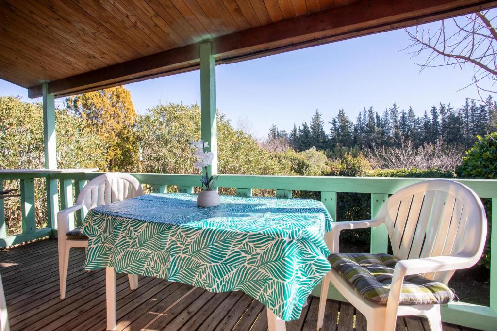 a table and two chairs on a deck at Chalet 2 FLAMANT ROSE in Roquebrune-sur-Argens