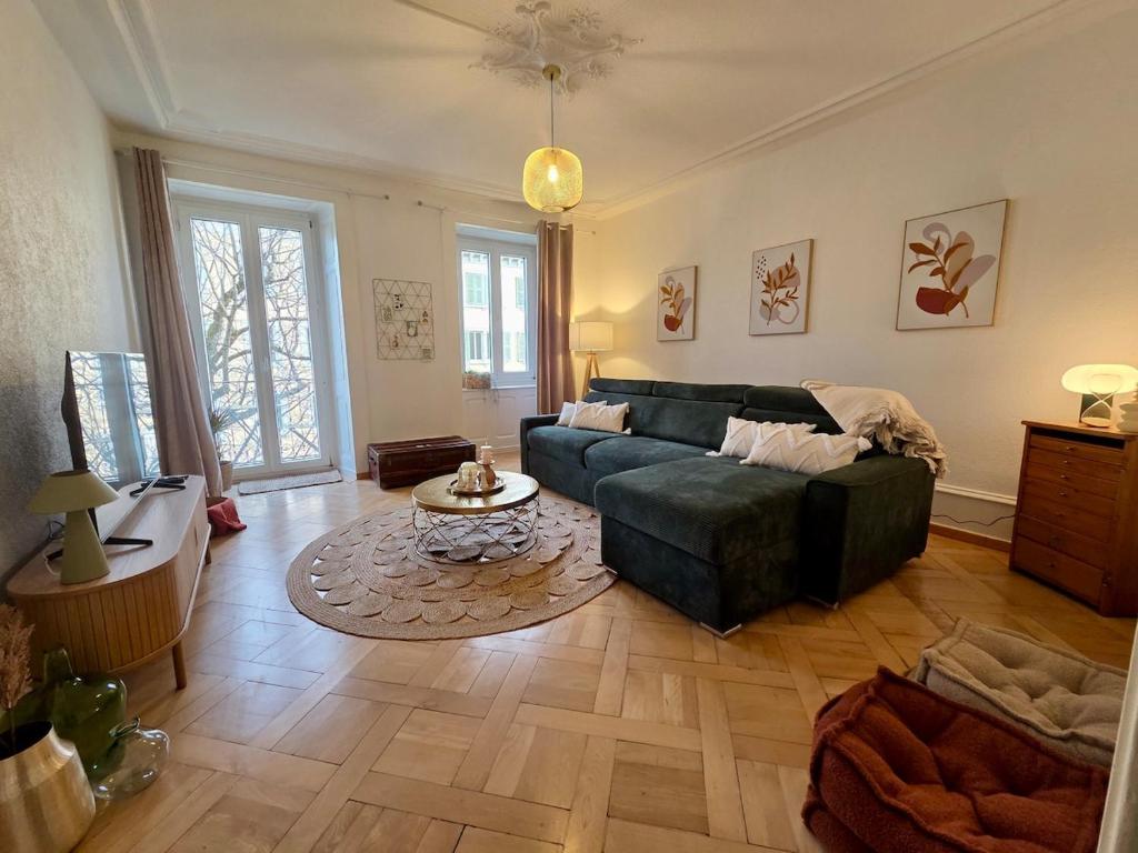 a living room with a couch and a table at La Maison de Jacob in La Chaux-de-Fonds