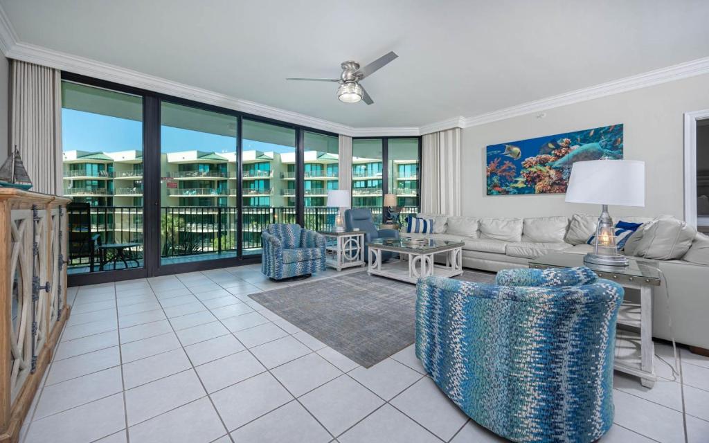 a living room with a couch and a table at Phoenix on the Bay 1328 in Orange Beach
