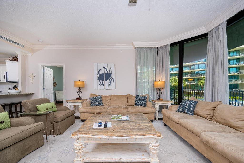 a living room with a couch and a table at Phoenix on the Bay 1109 condo in Orange Beach