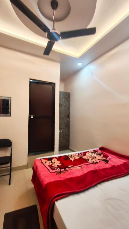 a bedroom with a bed with a ceiling fan at Royal guest house in Gorakhpur