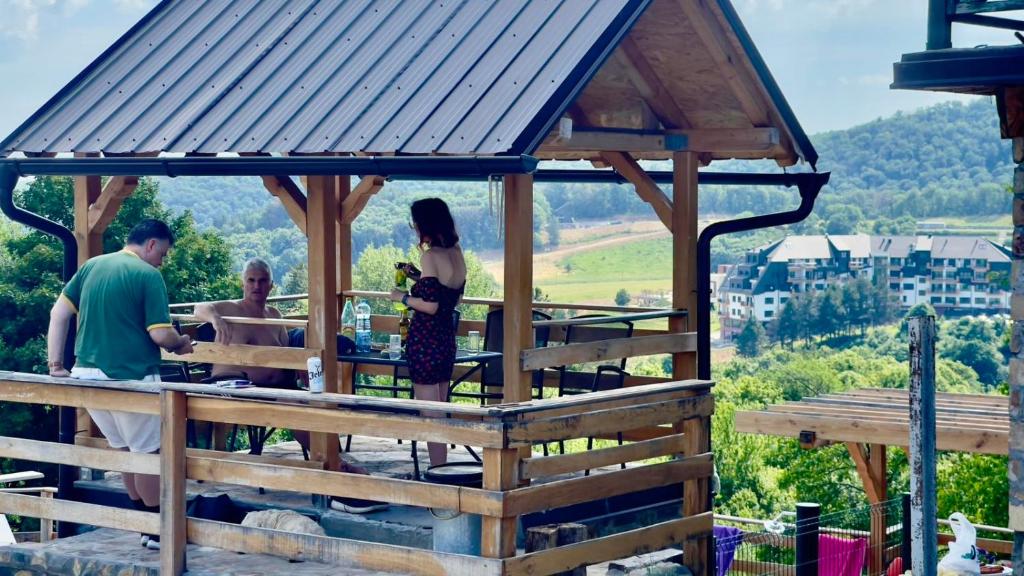 a group of people in a wooden gazebo at Apartmani Todorovic Ugore Vrdnik in Vrdnik