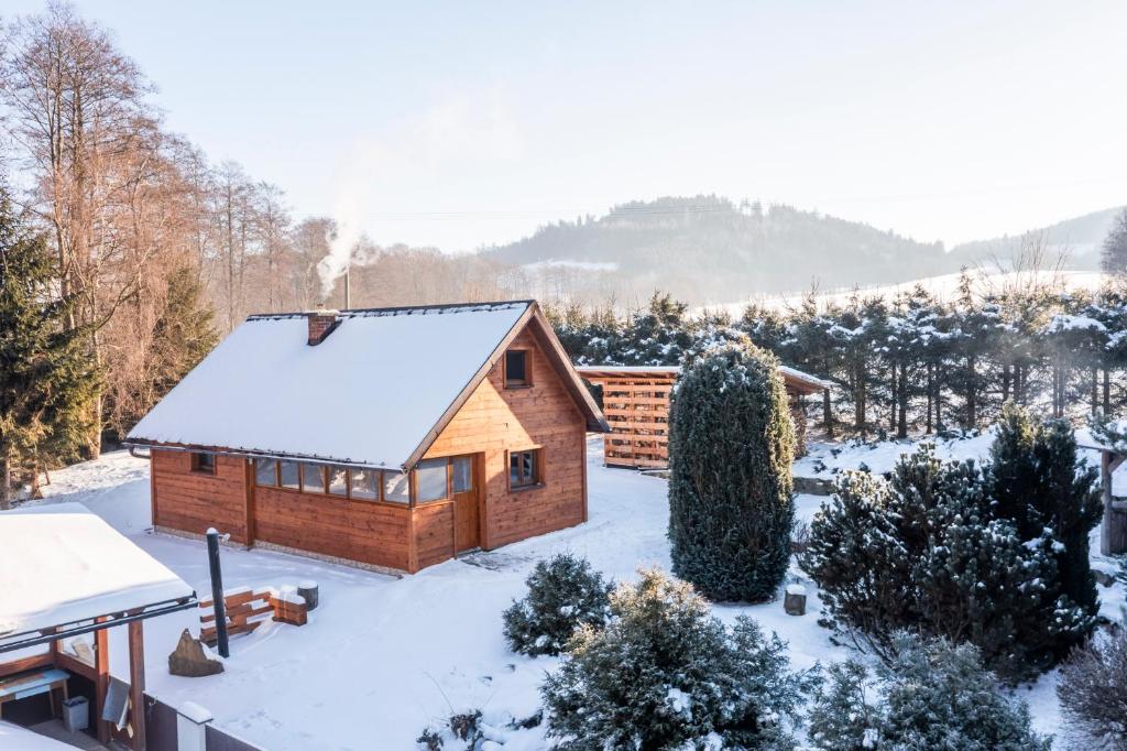 a log cabin with snow on the ground at Chata U Valentů in Červená Voda