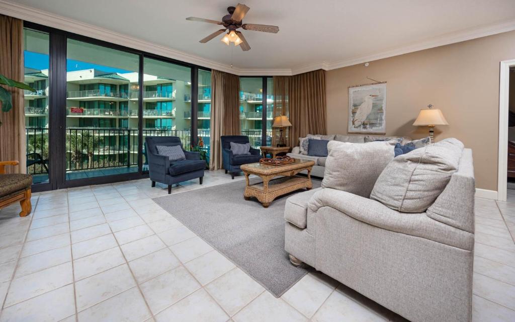 a living room with a couch and chairs at Phoenix on the Bay 1324 in Orange Beach