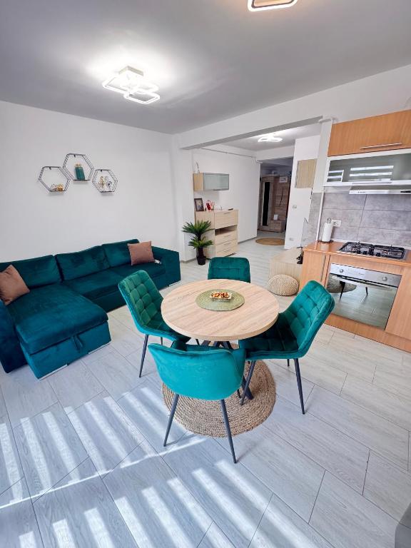 a living room with a couch and a table and chairs at CRISTAL Apartament Căpșunilor nr 2 in Craiova