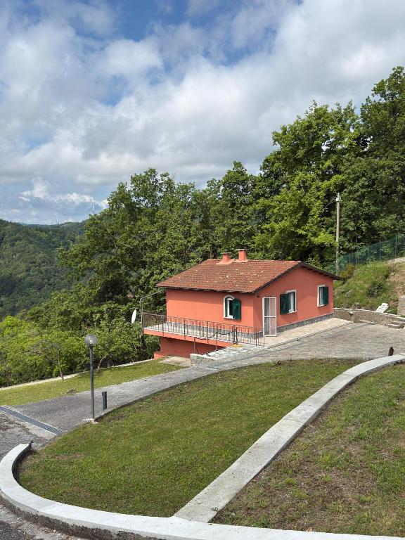 a small red house on the side of a road at Maltina country house in Savona
