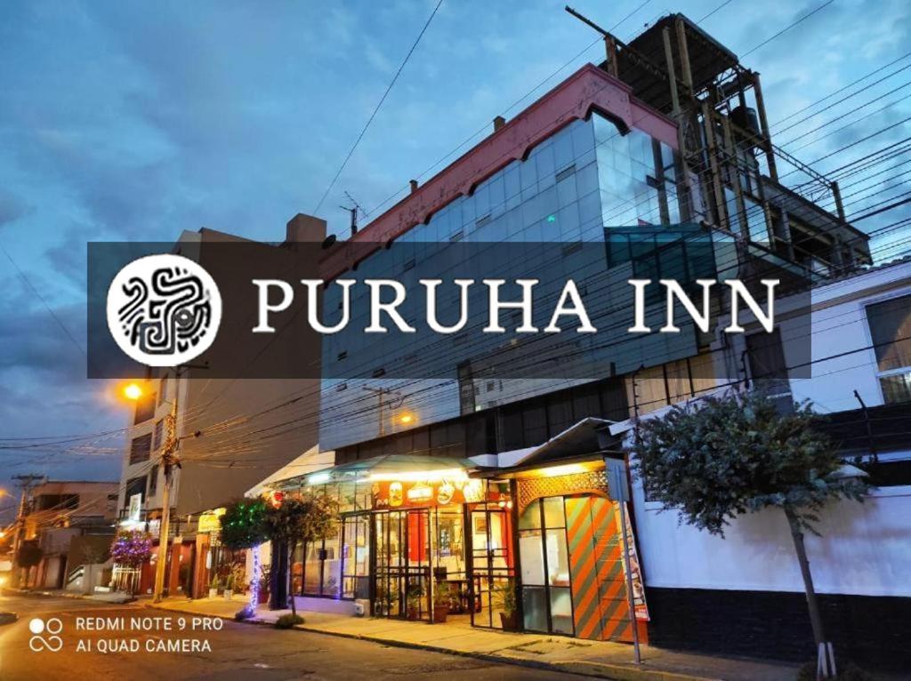 a building with a sign that reads puruna inn at Puruha Inn in Riobamba