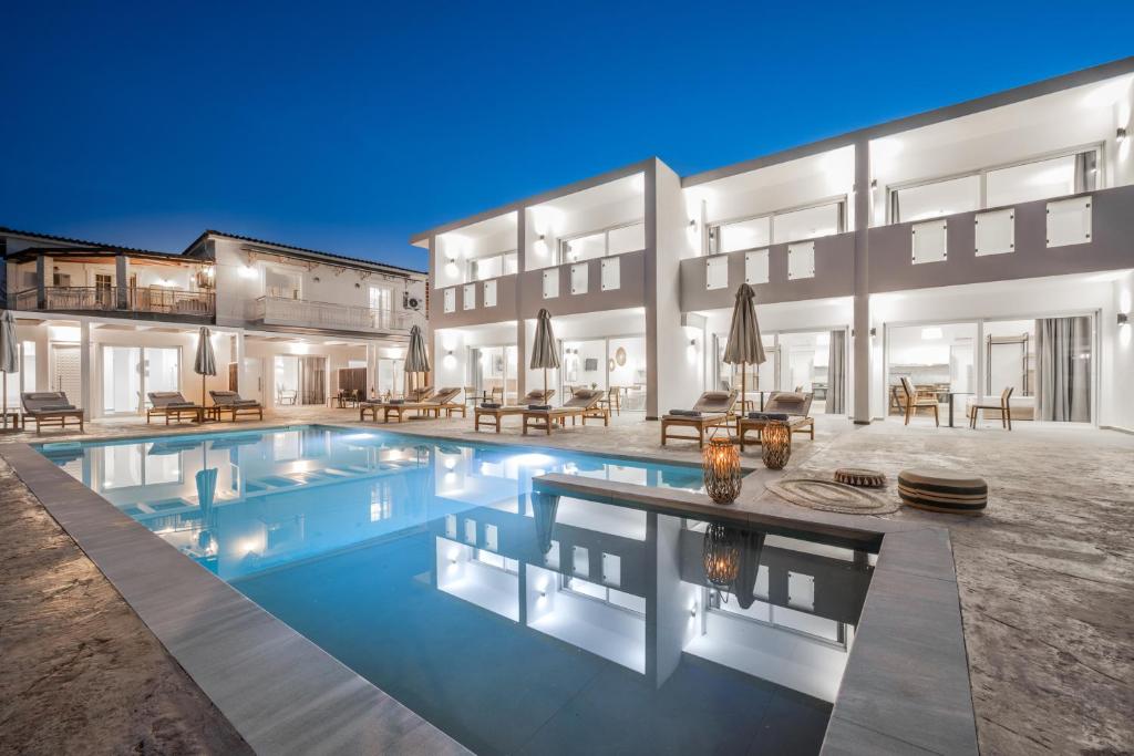 a swimming pool in front of a building at Sinati Luxury Studios Laganas Zakynthos in Laganas