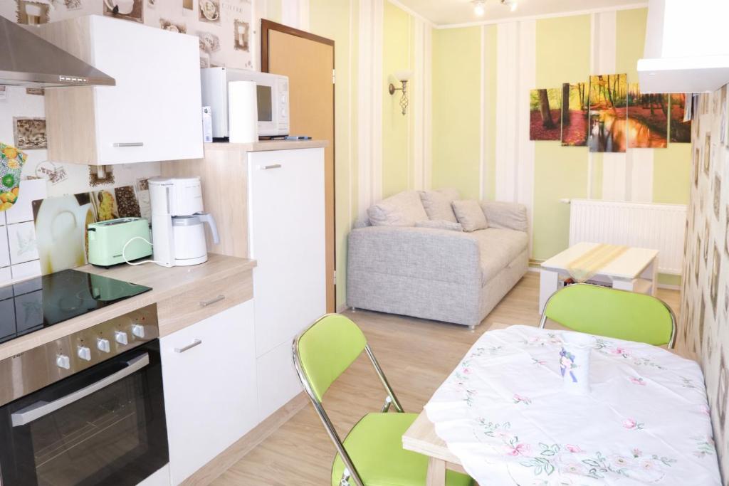 a kitchen with a table and two chairs in a room at Ferienwohnung Zur Rennsteigruh in Ruhla