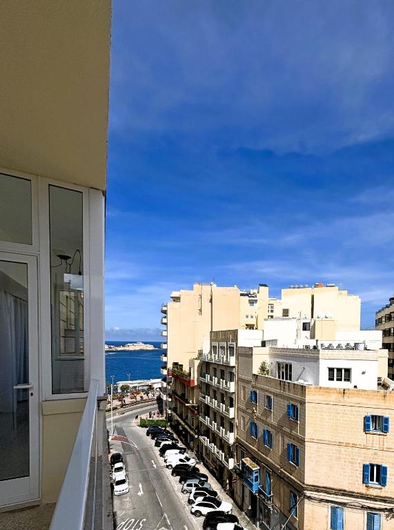 a view of a city from a balcony of a building at Sliema Penthouse 3 Ensuite Bedrooms Seaview - Zero55 in Sliema