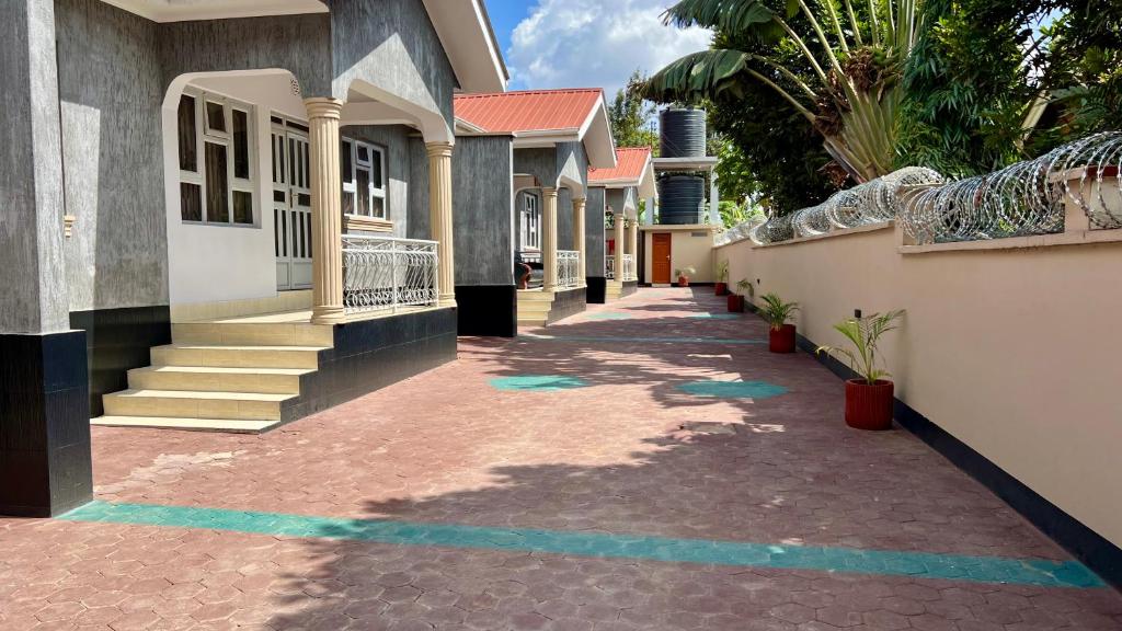 a walkway in front of a house with blue lines at Dolphin AIR B&B in Arusha