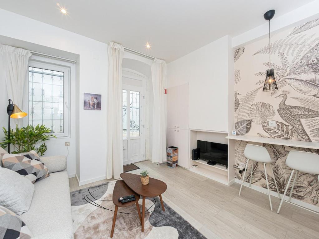 a living room with a couch and a fireplace at Beach House Old Town in Cascais