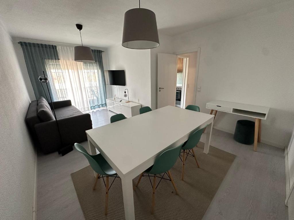 a living room with a white table and chairs at JP House in Figueira da Foz