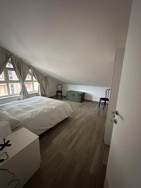 a white bedroom with a bed and a window at La Villa - Il Loft in Frosinone