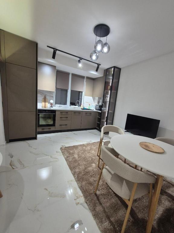 a kitchen with a table and chairs in a room at Апартамент Top Central in Yambol