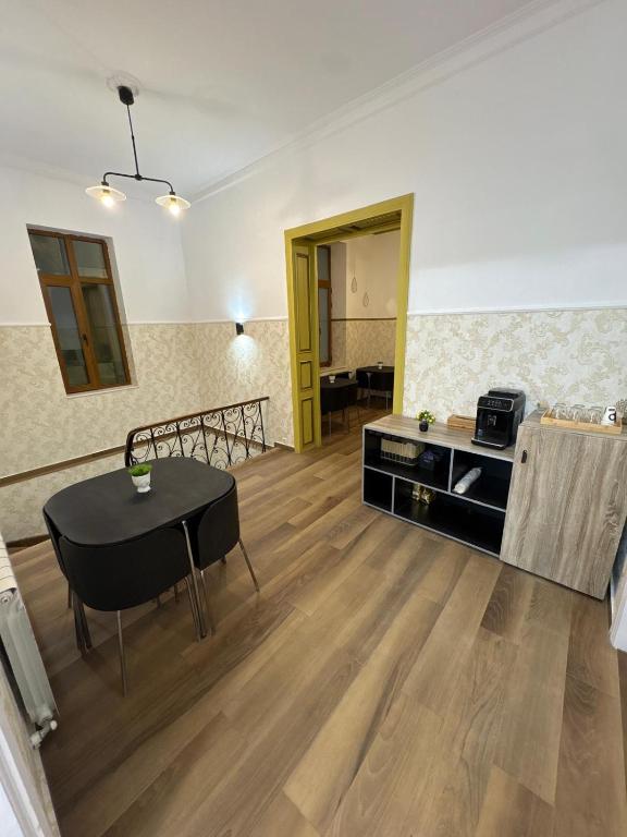 a living room with a table and a dining room at Villa Romana in Bucharest