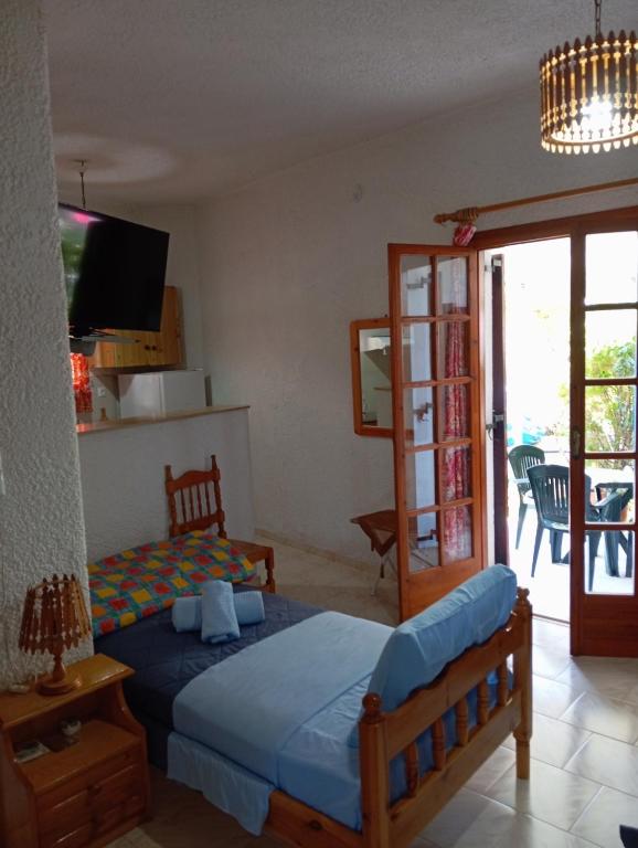 a bedroom with a bed and a sliding glass door at Akrata Golden Beach House in Aíyira