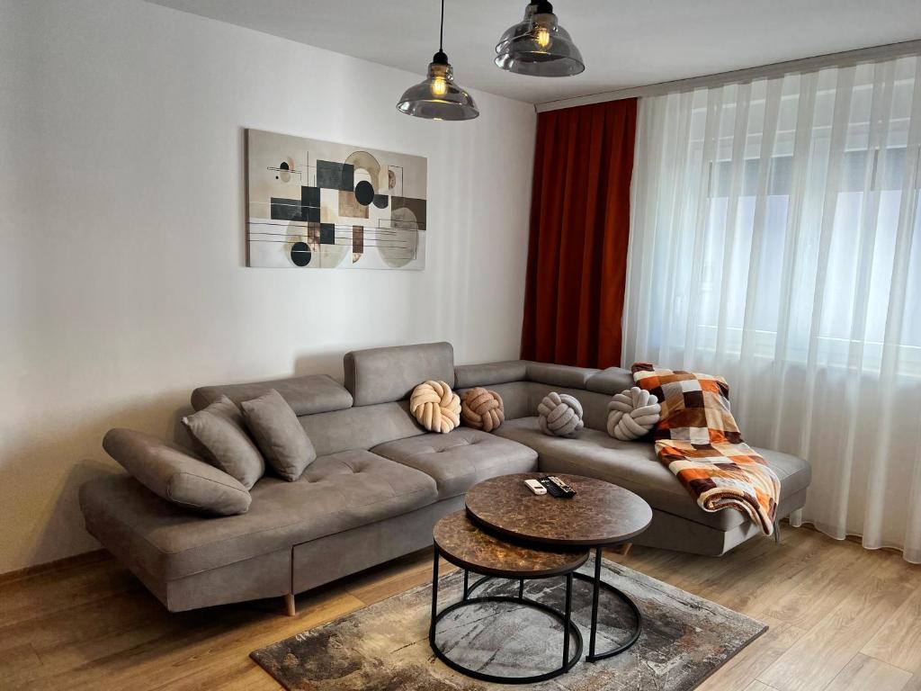 a living room with a couch and a table at Union Apartment in Ferizaj