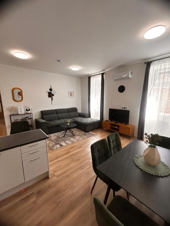 a living room with a couch and a table at R03 Central Residence in Sopron